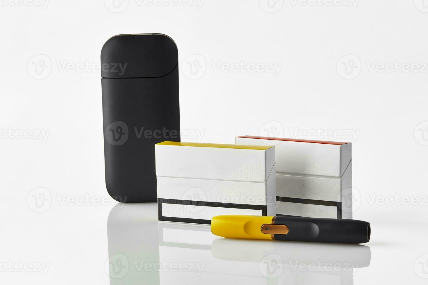Black and yellow electronic cigarette, battery, two packs and one of them with red side, isolated on white. Heating tobacco system. Close up photo