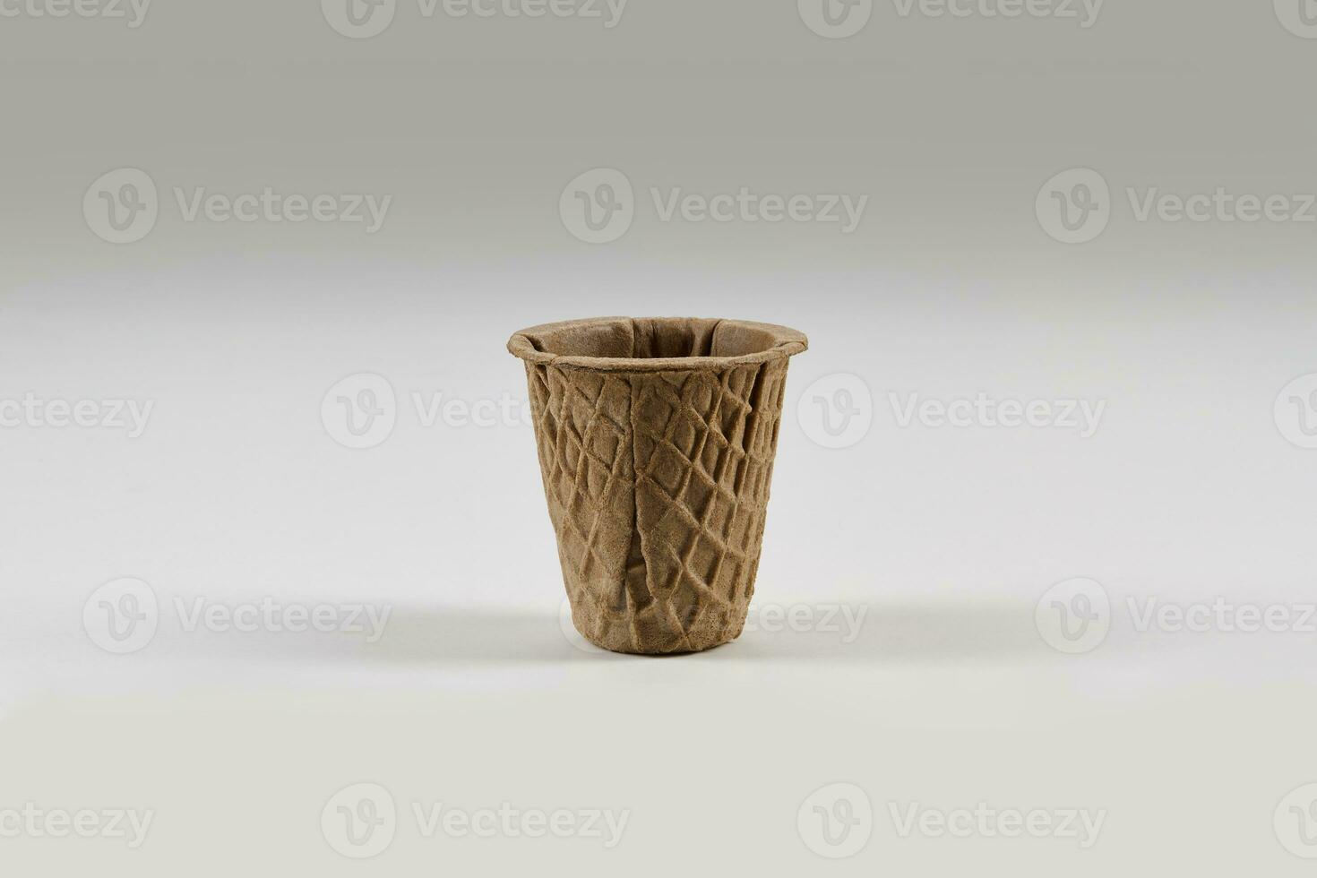 Empty , chocolate wafer cup for ice cream isolated on white background. Concept of food, treats. Mockup, template for advertising and design. Close up photo