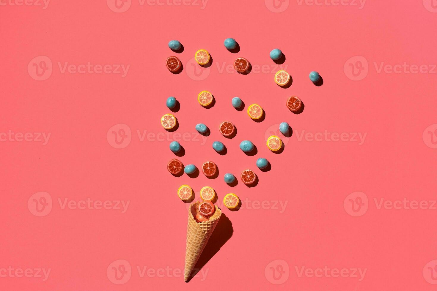 A variety of delicious sweets explode from the waffle cone, view from above. From left to the right direction photo