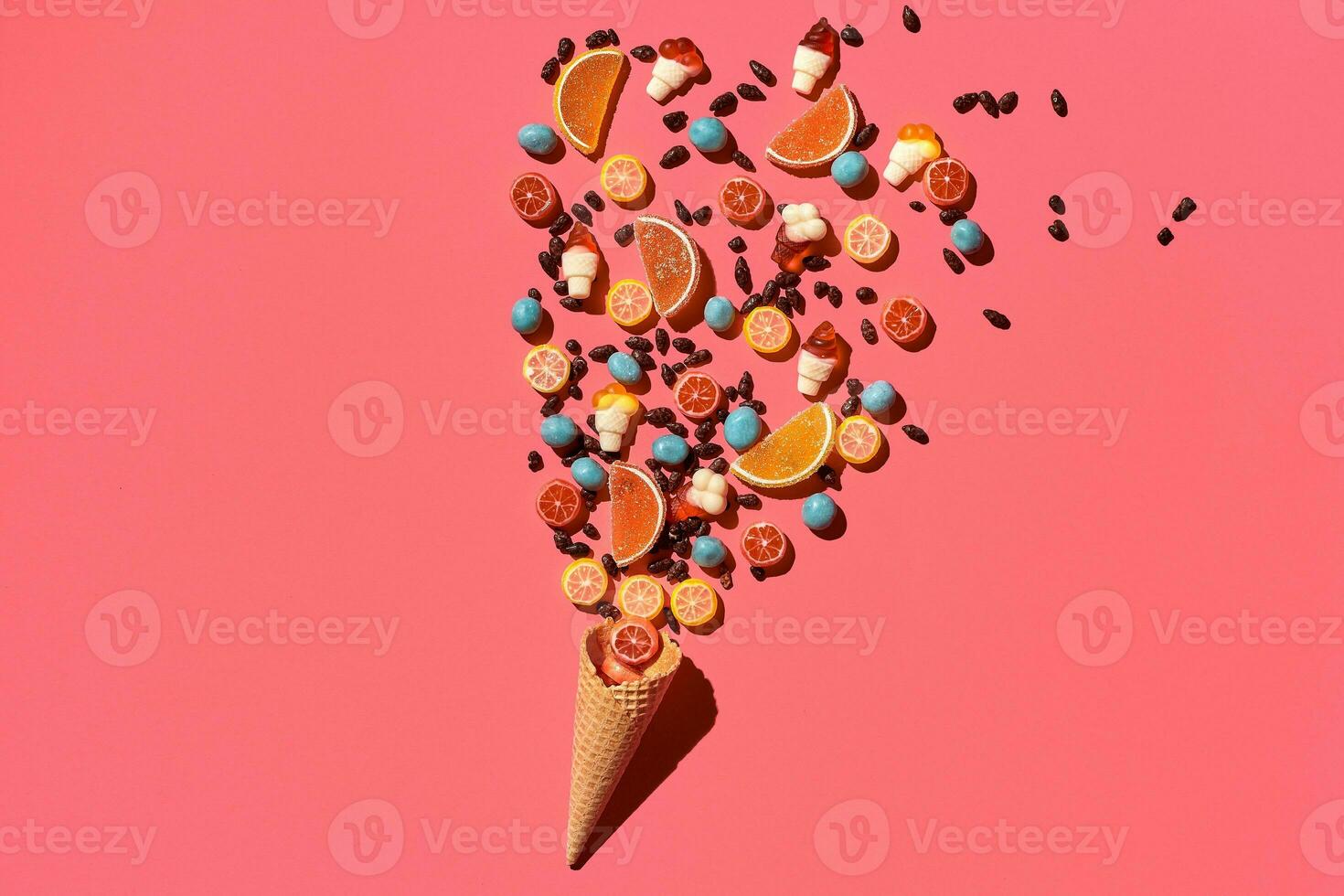 A variety of delicious sweets explode from the waffle cone, view from above. From left to the right direction photo