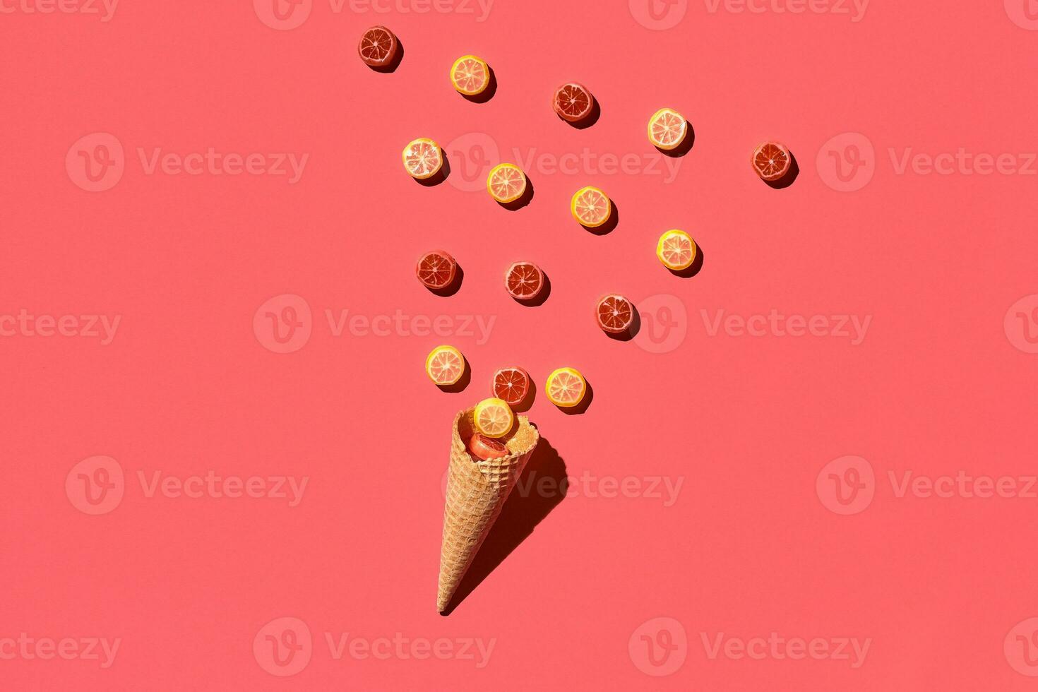 A variety of delicious sweets explode from the waffle cone, view from above. From left to the right direction photo