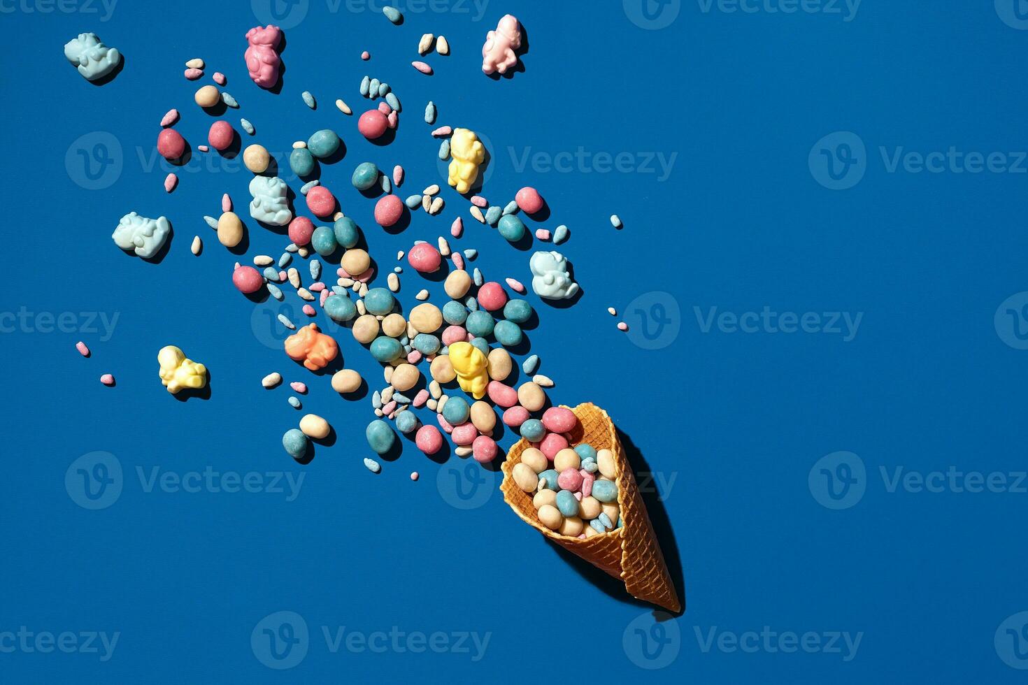 An image of a heap of dragee sweets that is sprinkled from a waffle cone photo