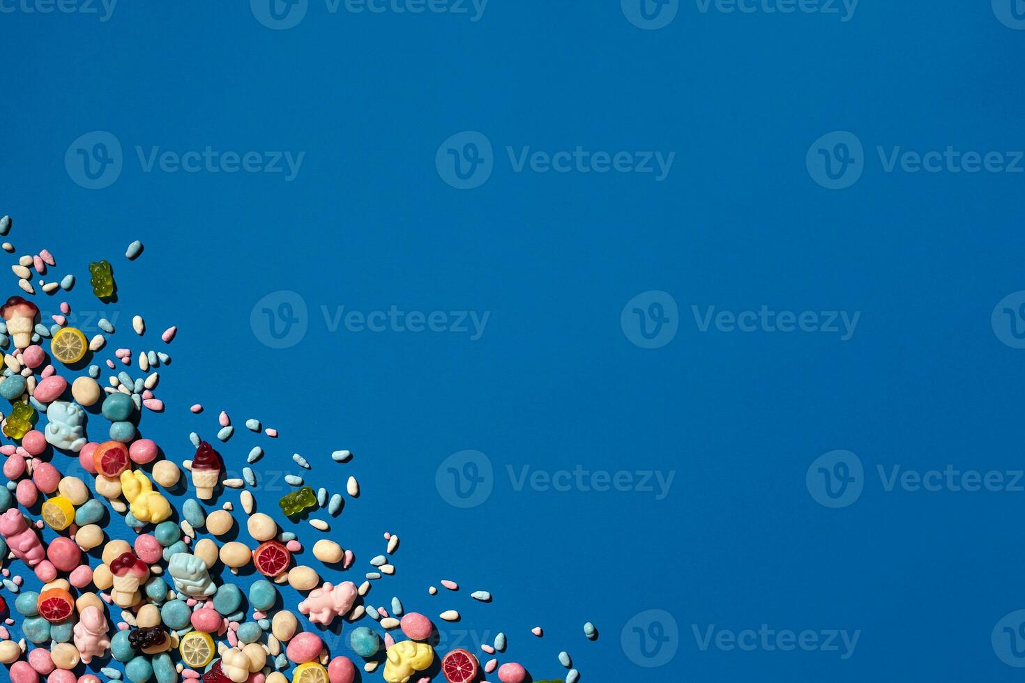 Photo of candies dragee placed on the corner of image with a copy space in the middle