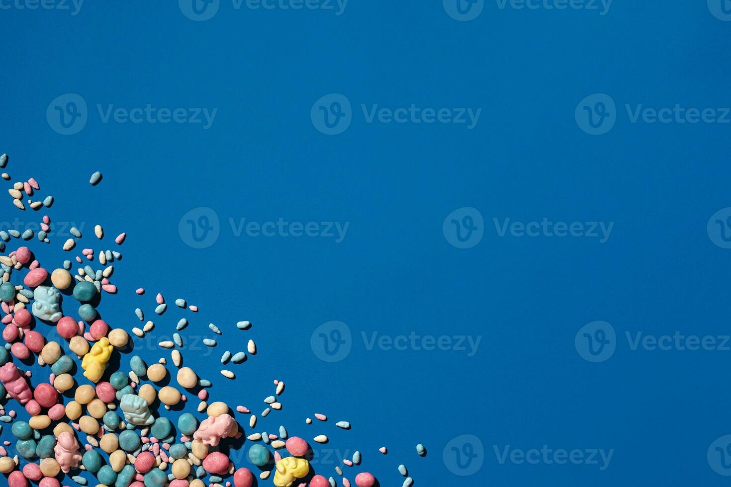 Photo of candies dragee placed on the corner of image with a copy space in the middle