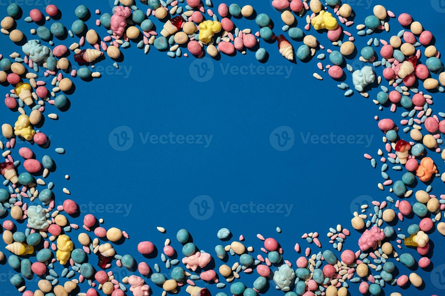 Photo of candies dragee placed on the perimeter of image with a copy space in the middle