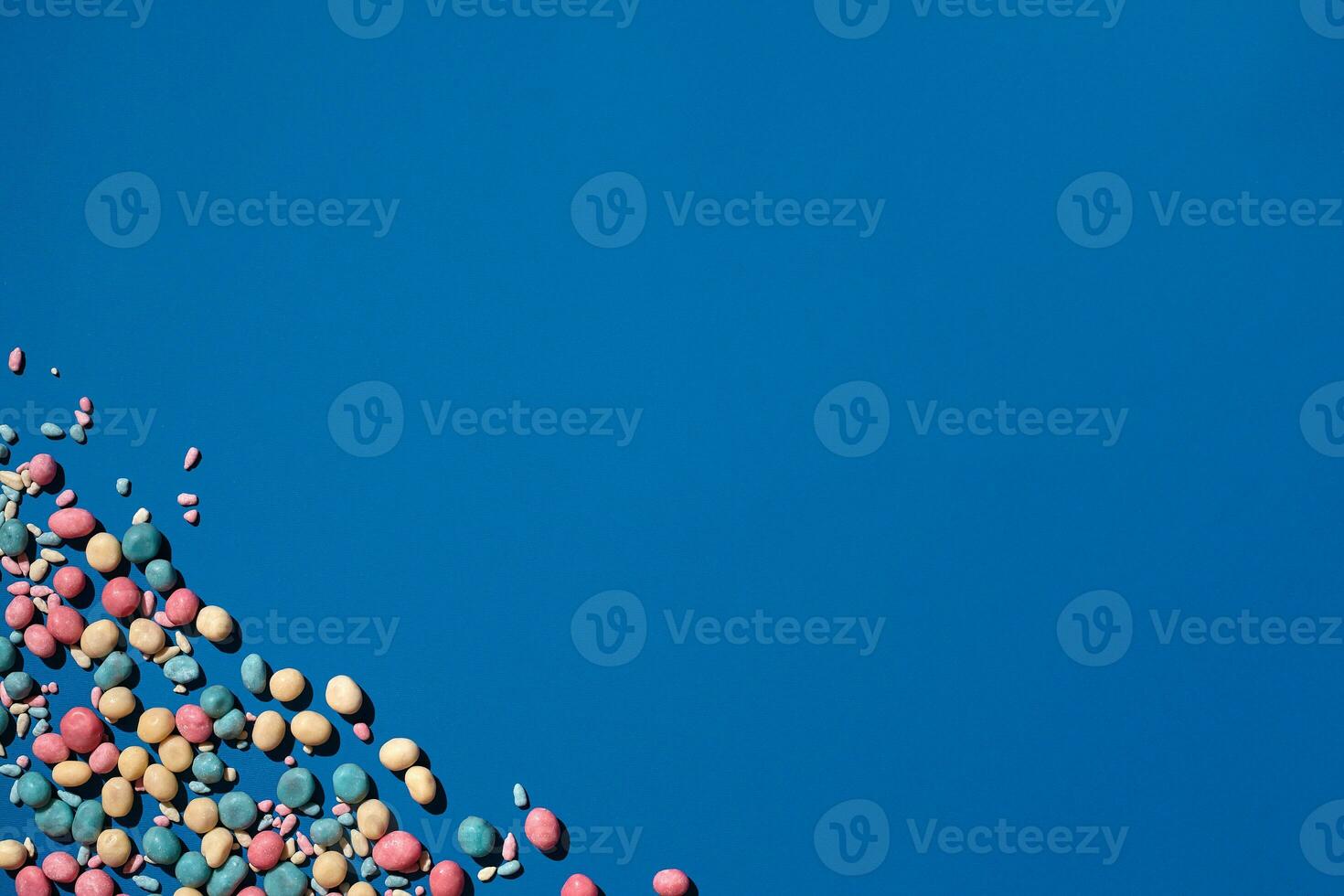 Photo of candies dragee placed on the corner of image with a copy space in the middle