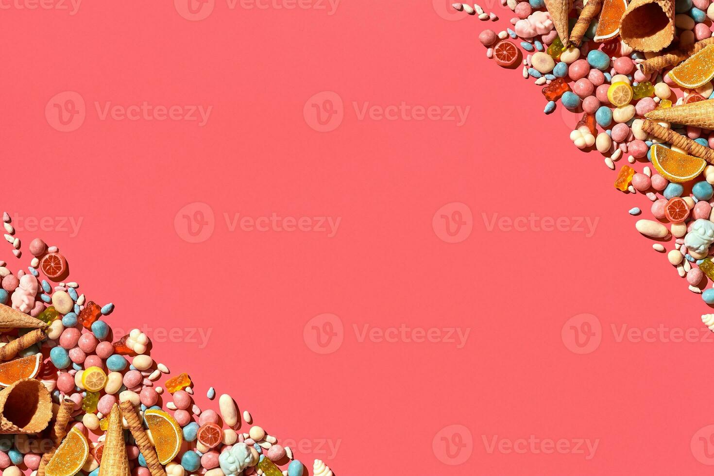 Various sweets, candys are palced on the photo on the coral background