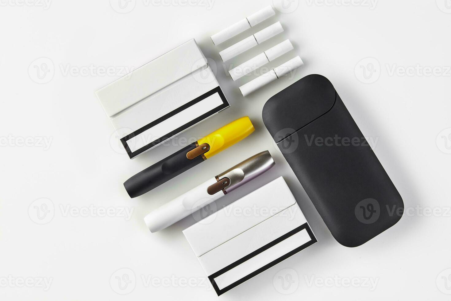 New generation black and yellow, white and silver electronic cigarettes, battery, two packs, four heatsticks isolated on white. Close up, copy space photo