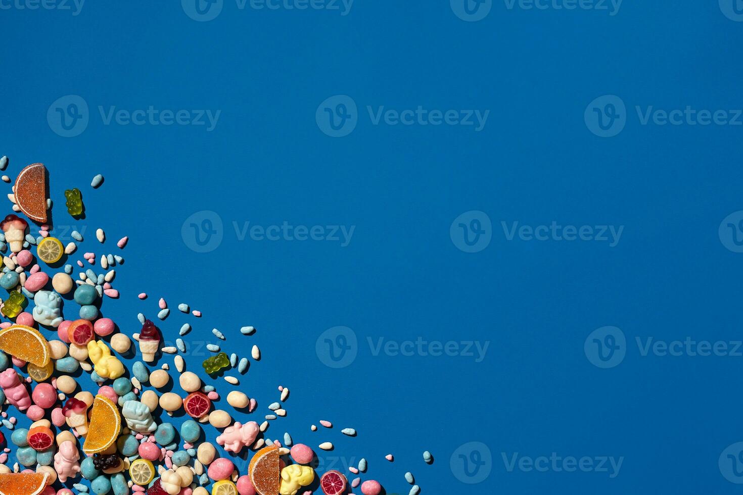 Photo of candies dragee placed on the corner of image with a copy space in the middle