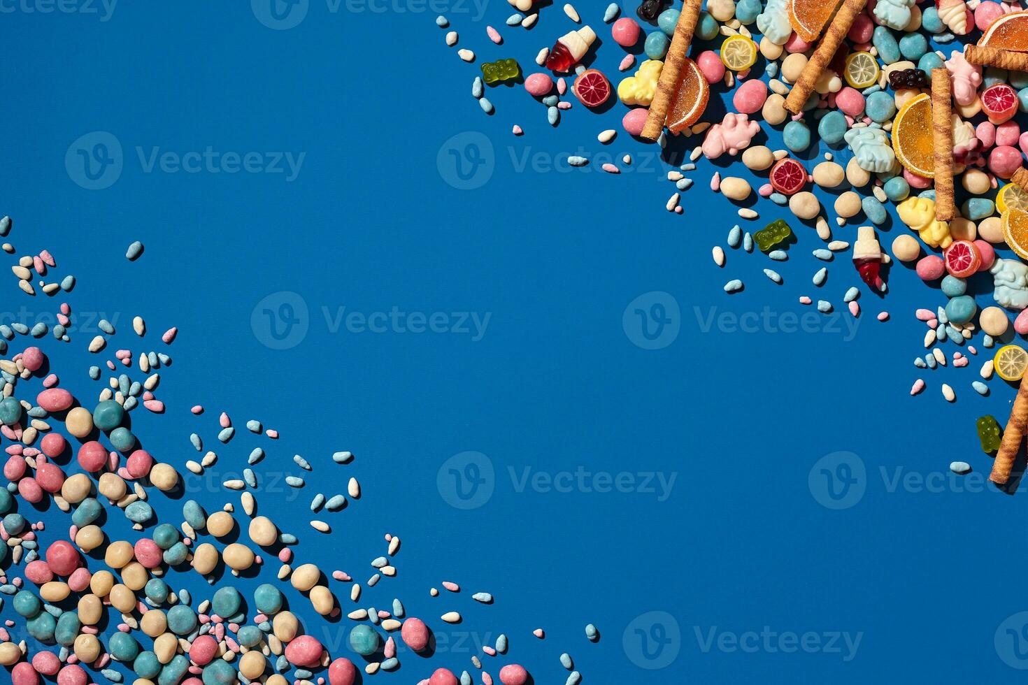 Photo of dragee candies placed on the opposite corners of image with a copy space in the middle