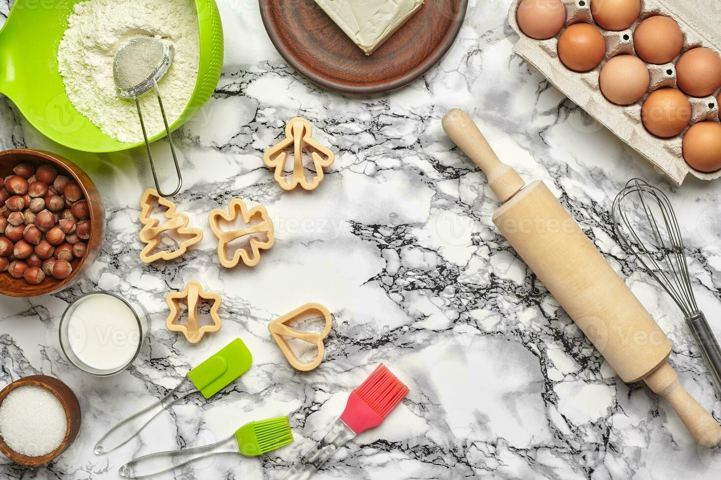 Close-up shot. Top view of a baking ingredients and kitchenware on the marble table background. photo