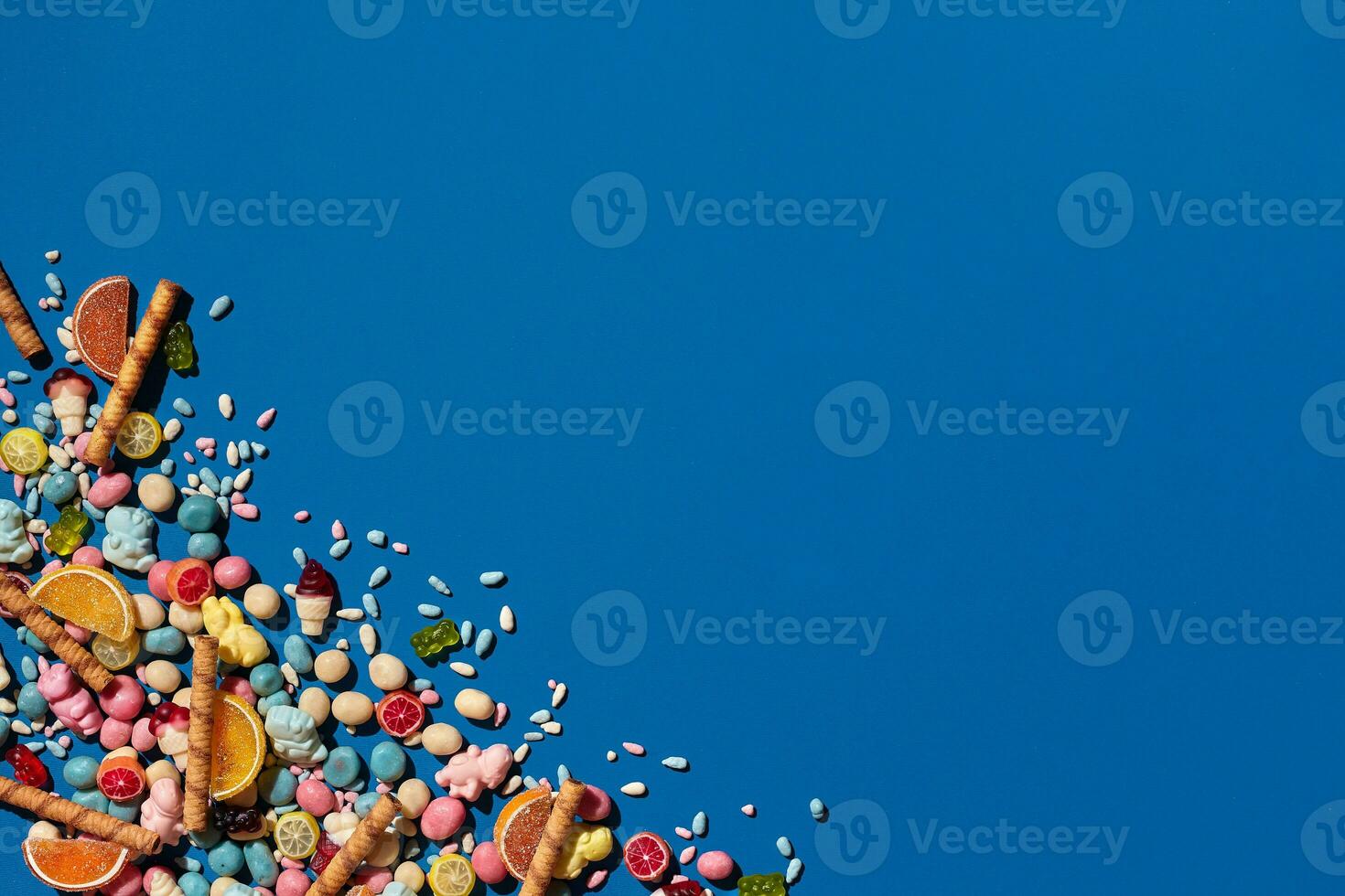 Photo of candies dragee placed on the corner of image with a copy space in the middle