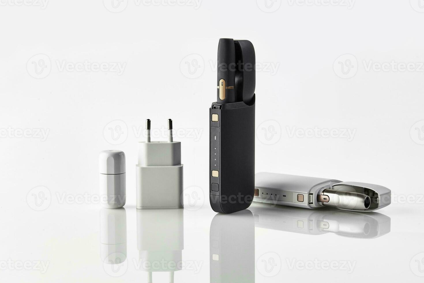 New generation black and white electronic cigarettes and open batteries isolated on white. Hi-tech heating tobacco system. Advertising, close up photo