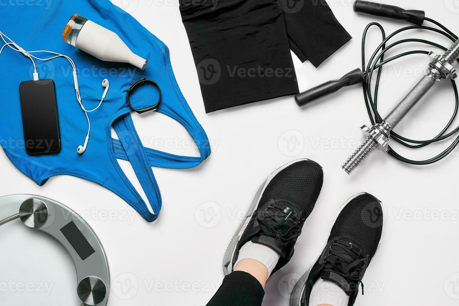 Sport woman sitting and resting after workout or exercise in fitness gym with protein shake or drinking water on floor. Relax concept. Flat lay photo