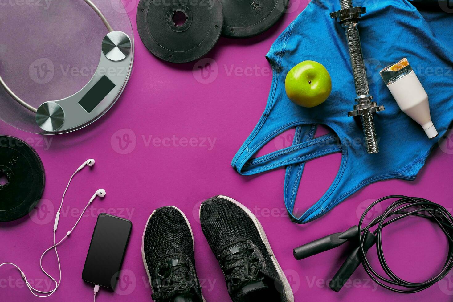 Fitness female outfit background top view. Set of sport clothing and equipment for women, active lifestyle photo
