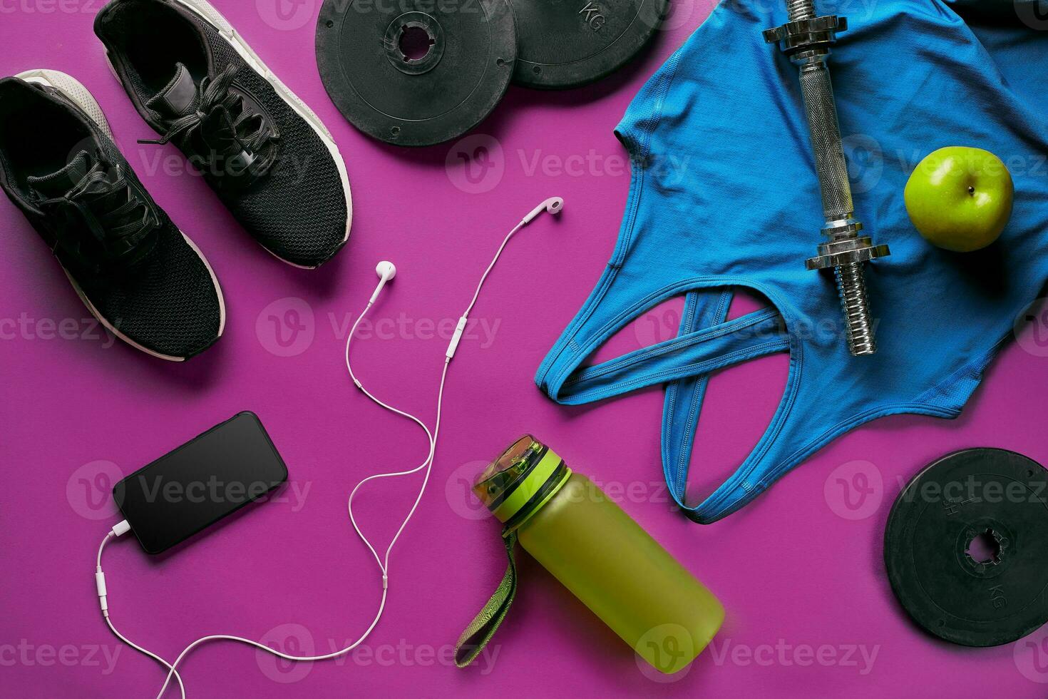 Fitness female outfit background top view. Set of sport clothing and equipment for women, active lifestyle photo