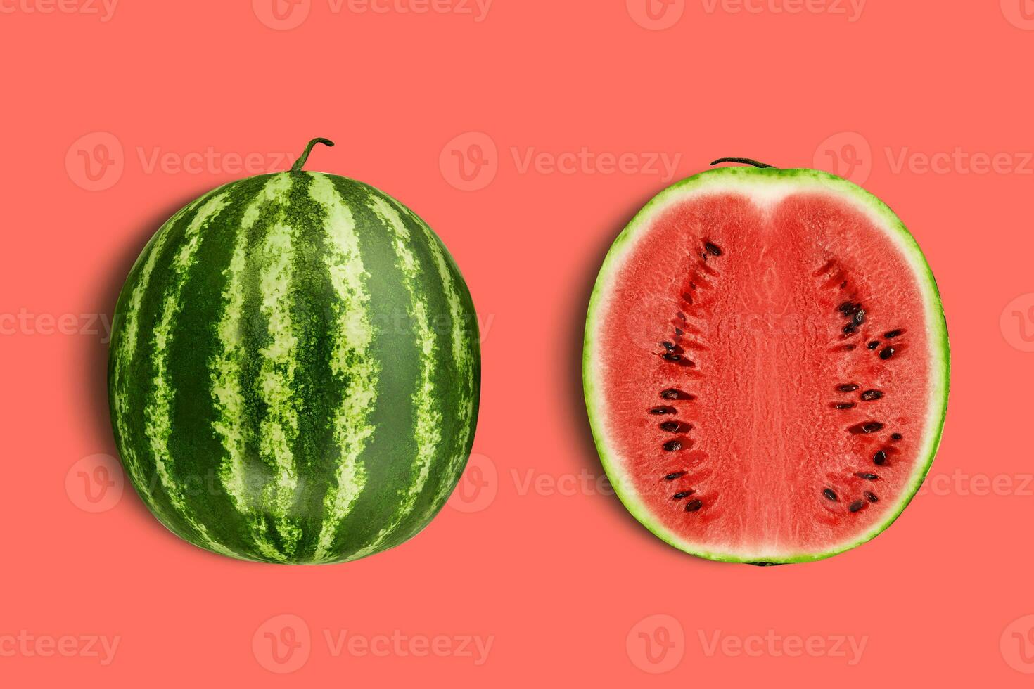 Green, striped watermelon, pink background with copy space for text, images. Cross-section. Berry with red flesh, black seeds. Top view. Close-up. photo