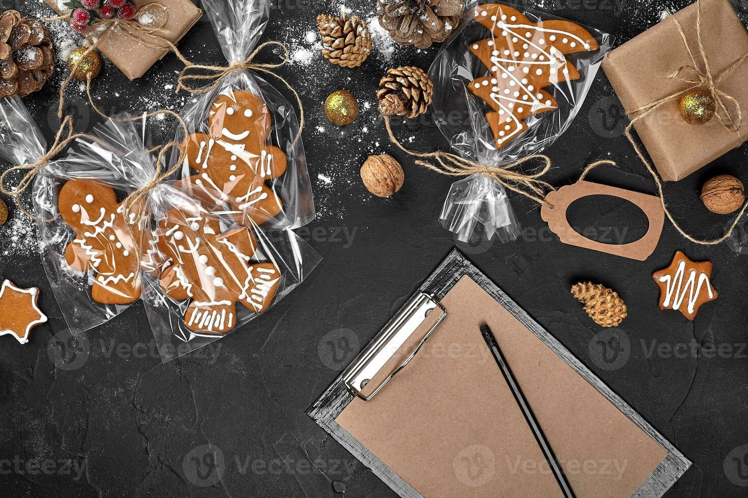 Christmas background with gingerbread cookies and craft sheets of paper. Copy space. photo