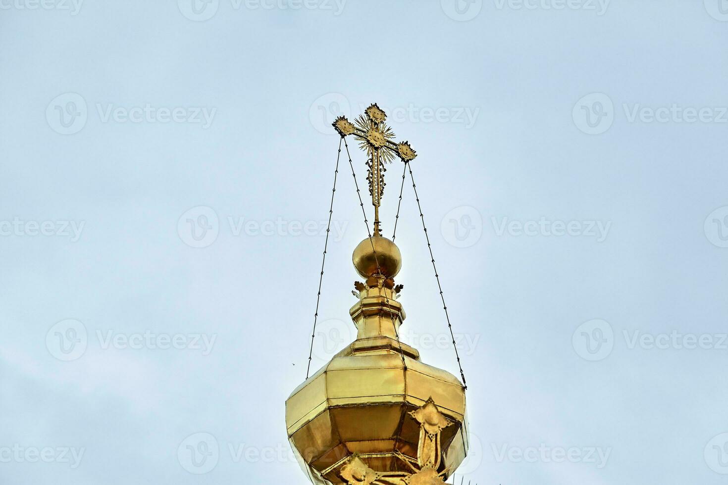 Eastern orthodox crosses on gold domes, cupolas, against blue sky with clouds photo