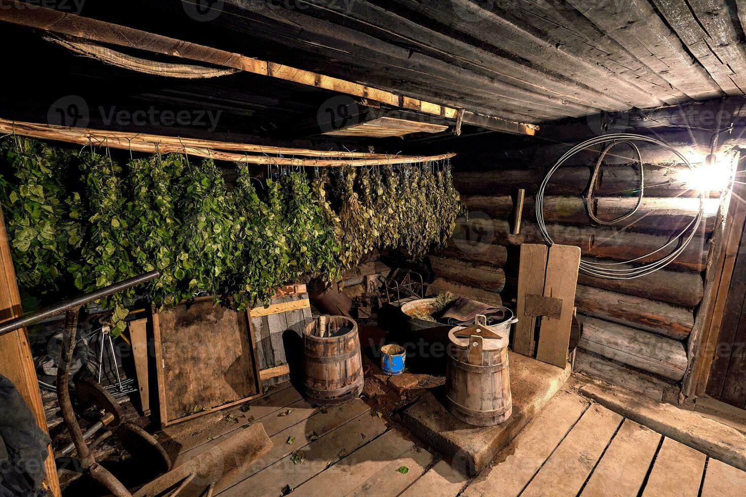 Dried herbs and branches on wooden background of ancient bathhouse photo