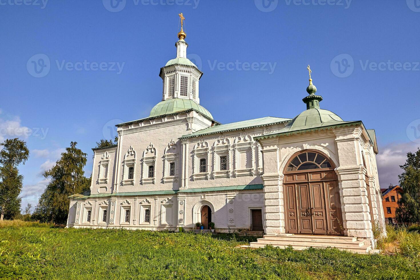 Old orthodox church at village. Summer view with floral meadow. photo