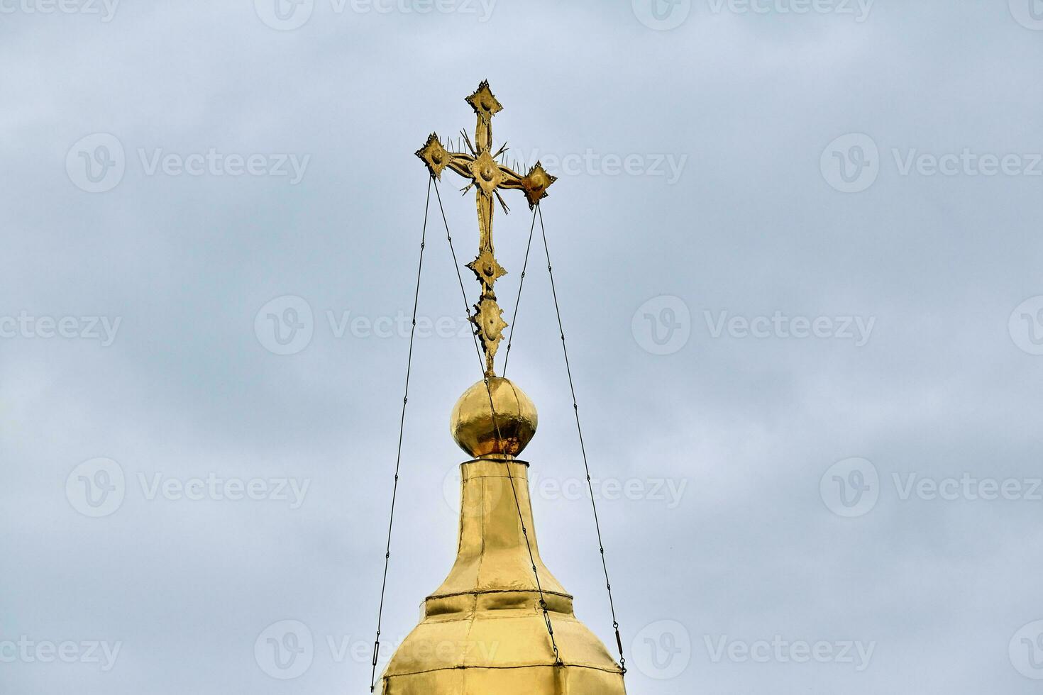 Eastern orthodox crosses on gold domes, cupolas, against blue sky with clouds photo