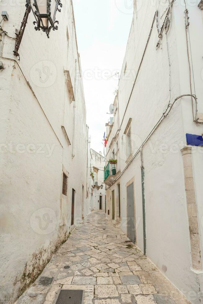 View of the old town of Martina Franca with a beautiful houses painted in white. photo