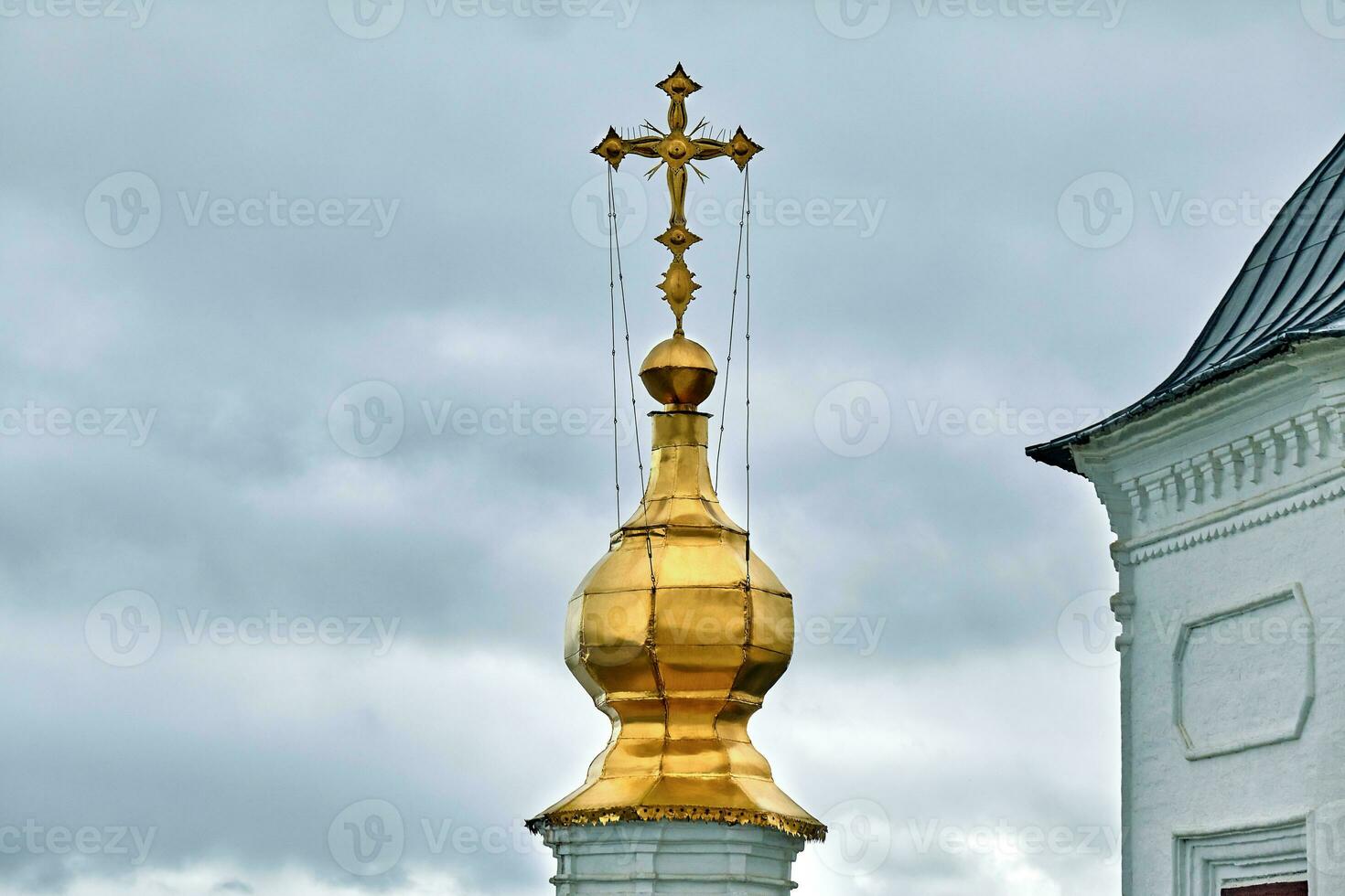 Eastern orthodox crosses on gold domes, cupolas, against blue sky with clouds photo