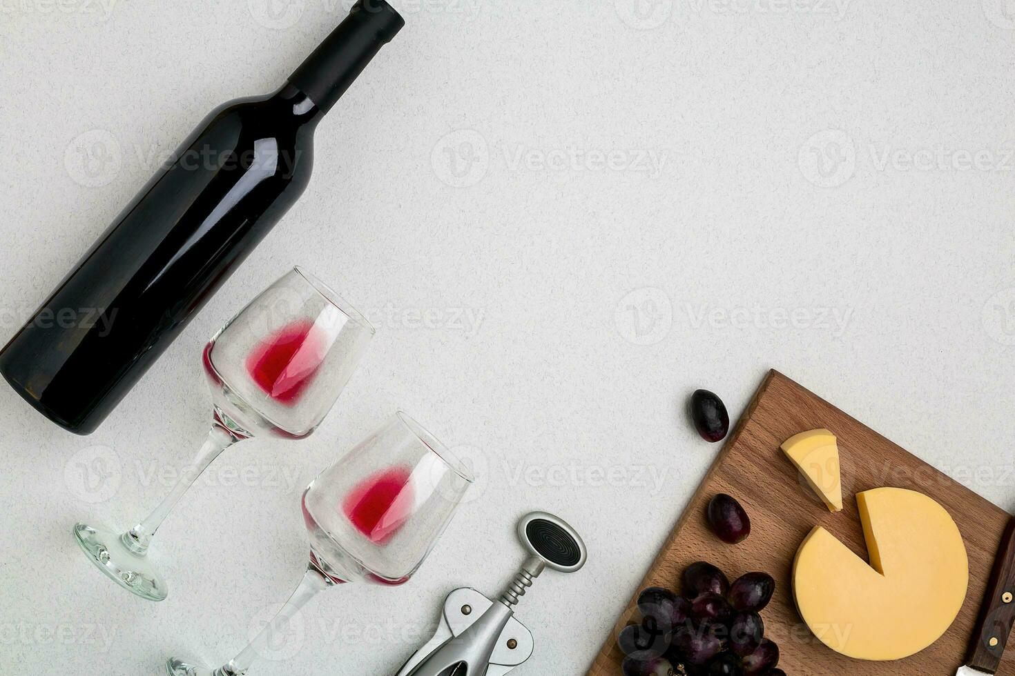 Wine, glasses and corkscrew over white background. Top view photo