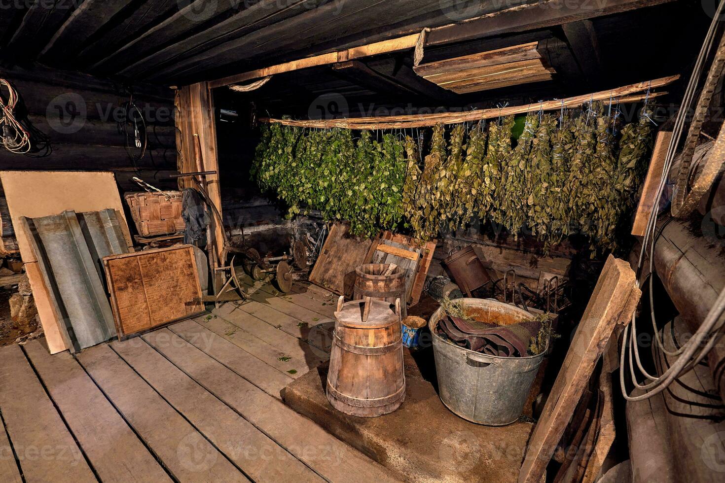 Dried herbs and branches on wooden background of ancient bathhouse photo