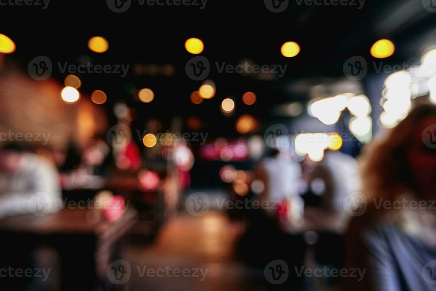 Blurred restaurant or cafe background. Tables and chairs in the lobby of the mall. Visitors to the restaurant for dinner. Beautiful bright interior. photo