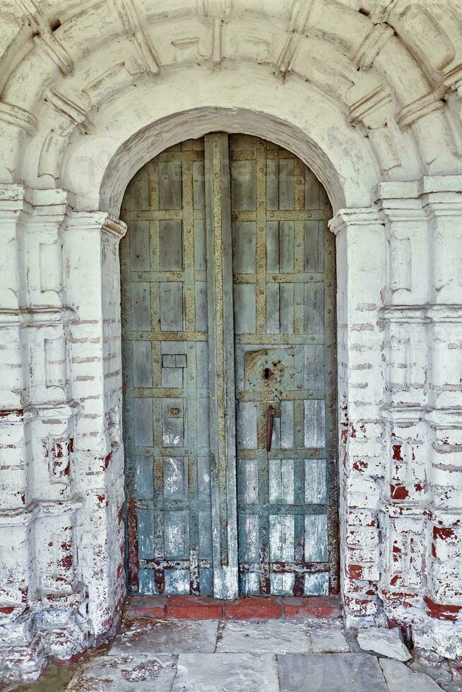 Locked wooden door of the old orthodox church photo