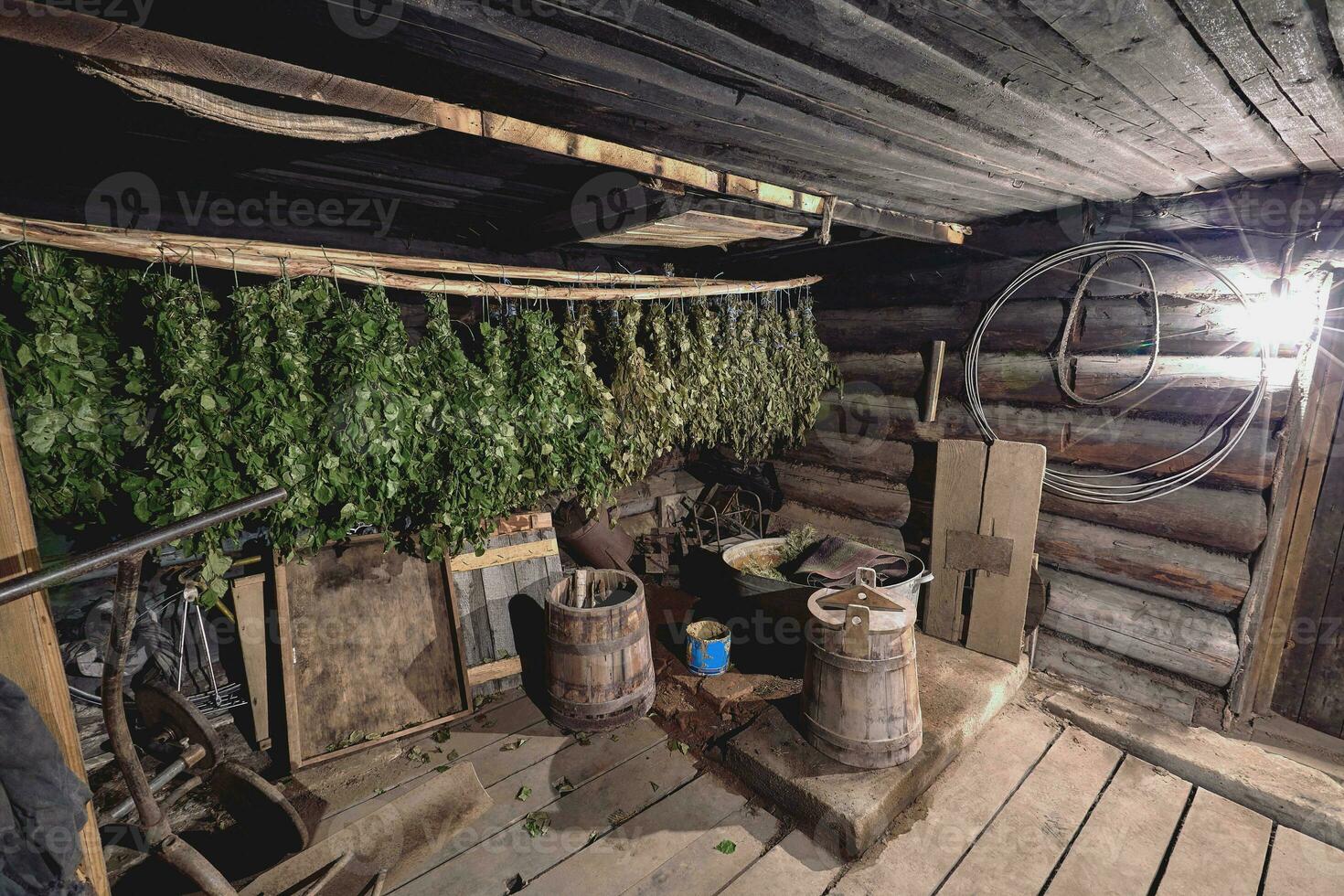 Dried herbs and branches on wooden background of ancient bathhouse photo