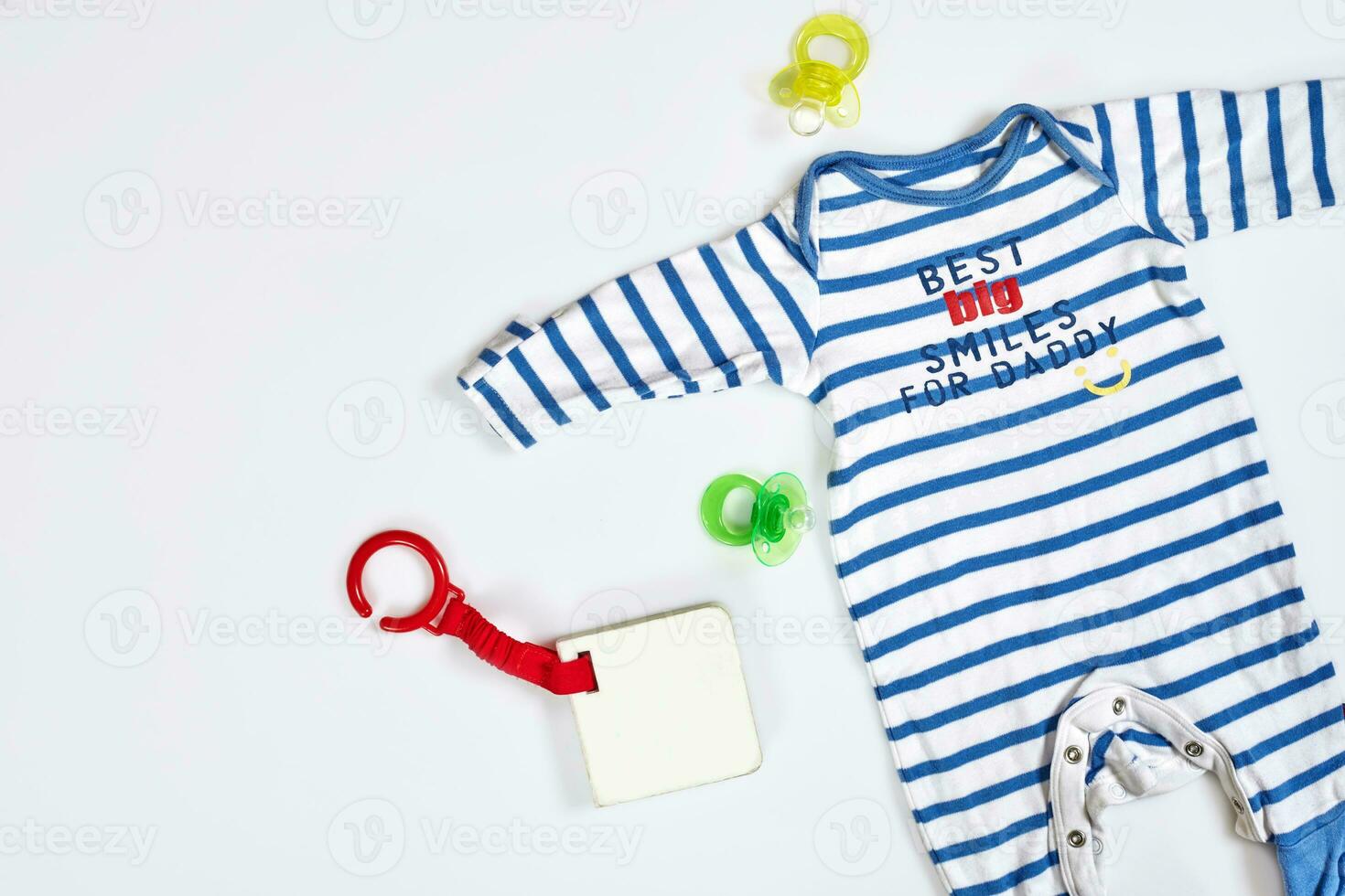 Baby care accessories and clothing on light background, top view photo