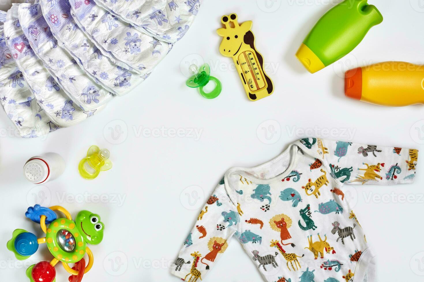 Baby care accessories and clothing on white background, top view photo