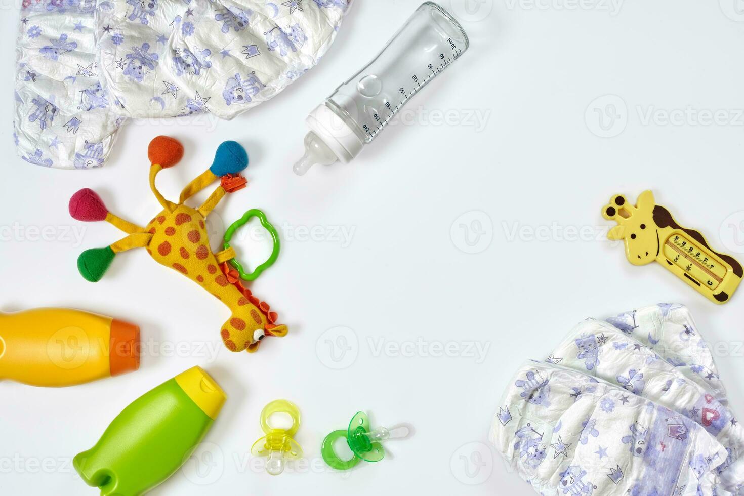 Set of accessories for baby. Pacifier, bottle, diaper, cream on white background. photo