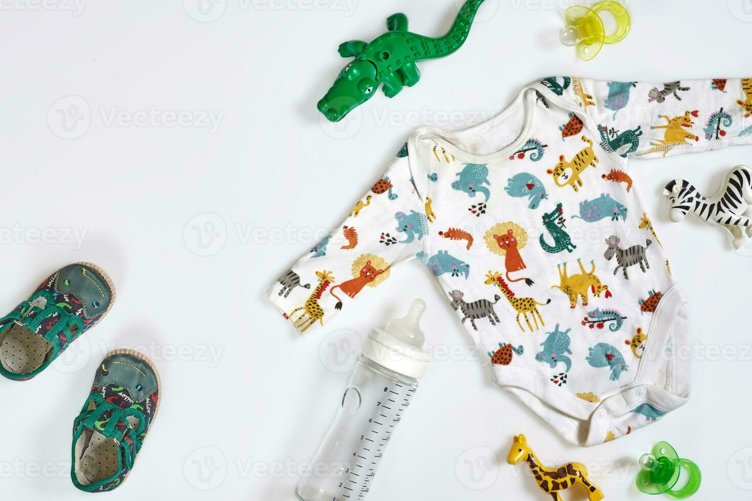 Baby care accessories and clothing on white background, top view photo