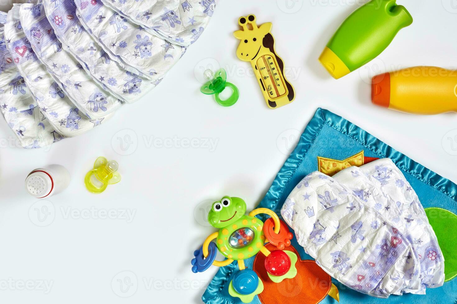 Set of accessories for baby. Pacifier, bottle, diaper, cream on white background. photo