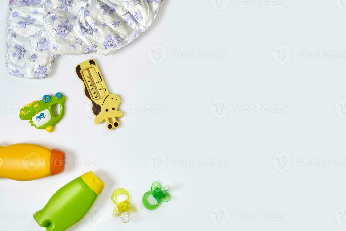 Set of accessories for baby. Pacifier, bottle, diaper, cream on white background. photo