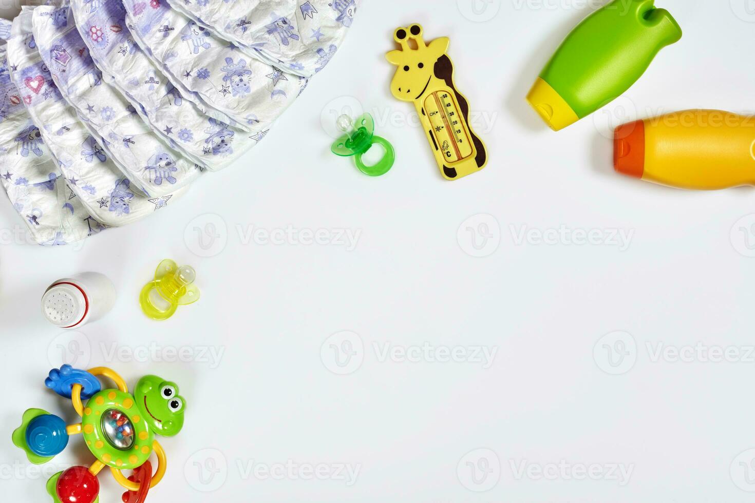 Babies goods diaper, soother or nipple on white background with copy space. Top view or flat lay. photo