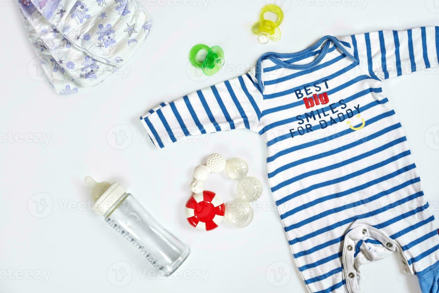 Baby care accessories and clothing on light background, top view photo