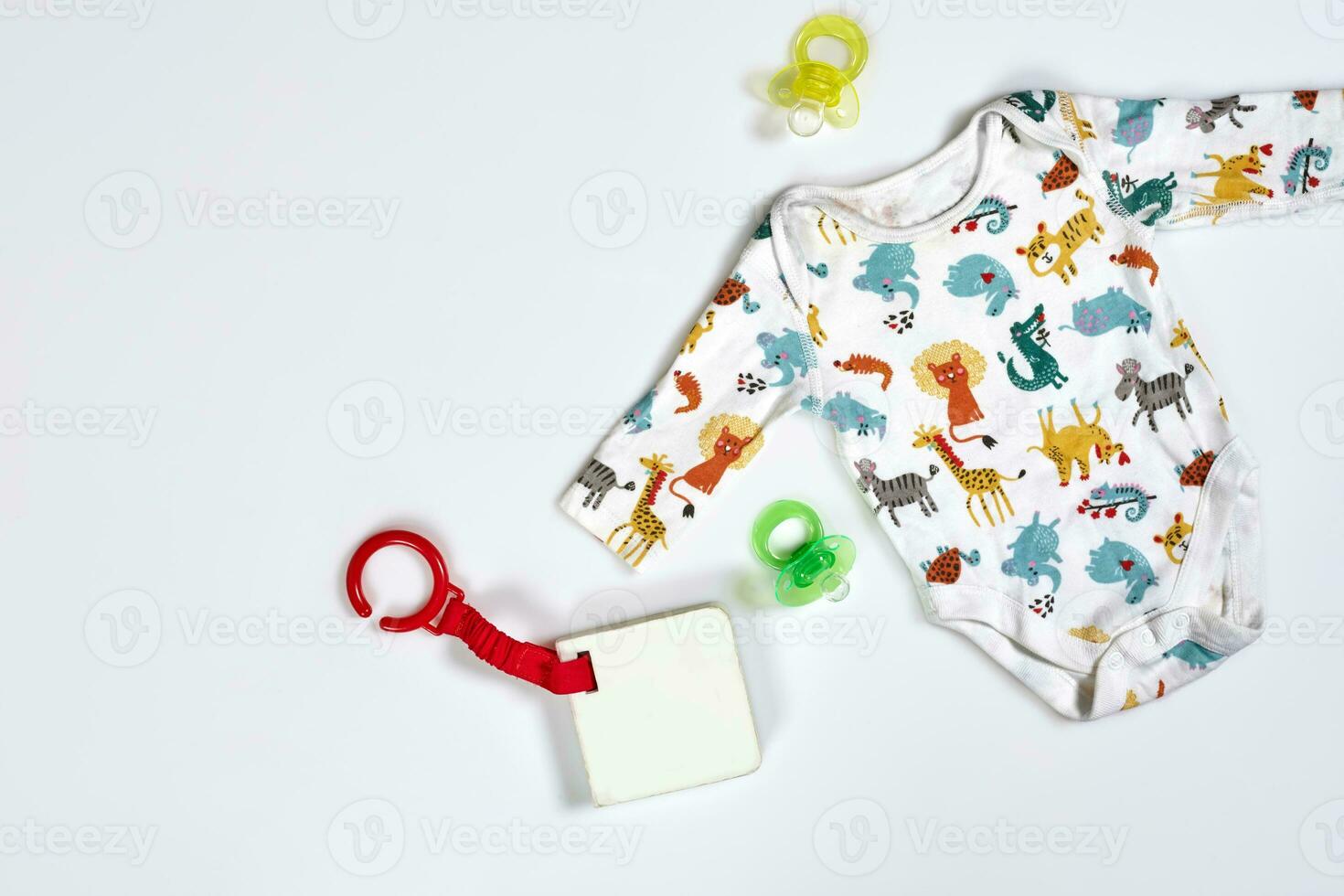 Baby care accessories and clothing on white background, top view photo