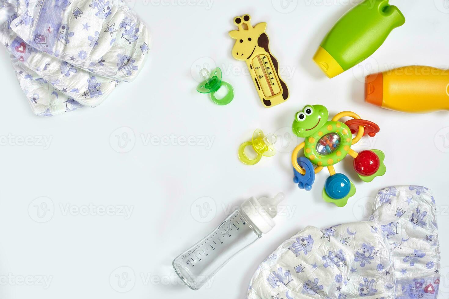 Set of accessories for baby. Pacifier, bottle, diaper, cream on white background. photo