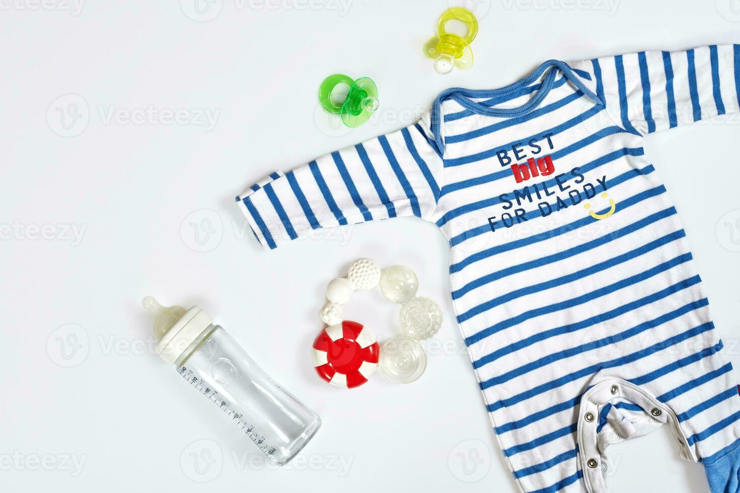 Baby care accessories and clothing on light background, top view photo