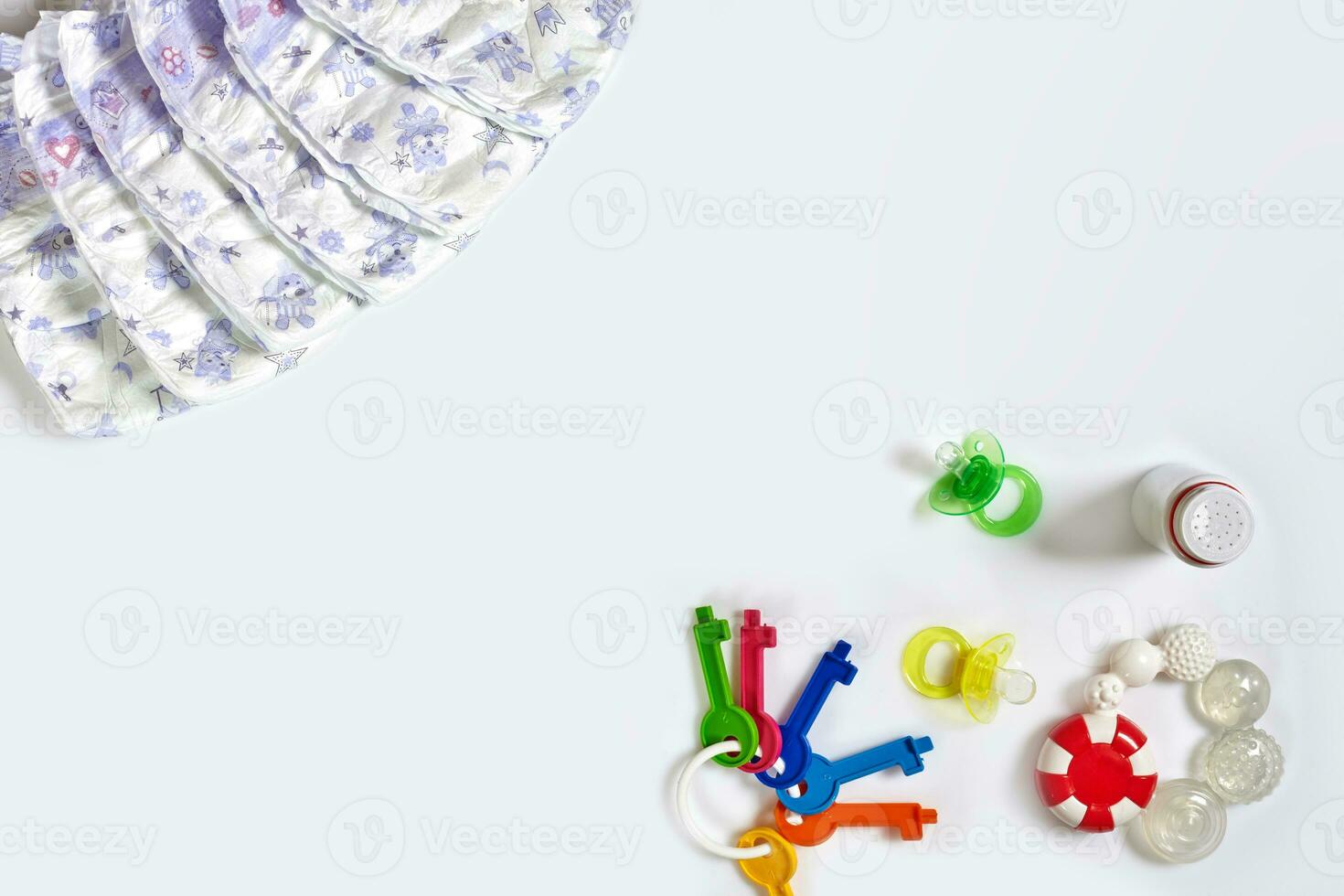 Babies goods diaper, soother or nipple on white background with copy space. Top view or flat lay. photo