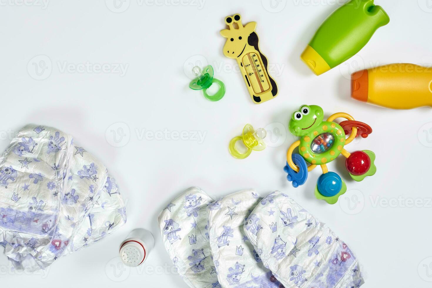 Set of accessories for baby. Pacifier, bottle, diaper, cream on white background. photo