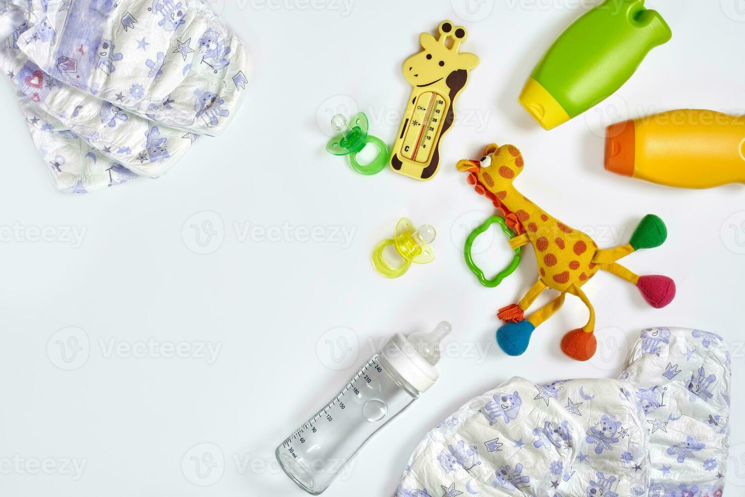 Set of accessories for baby. Pacifier, bottle, diaper, cream on white background. photo