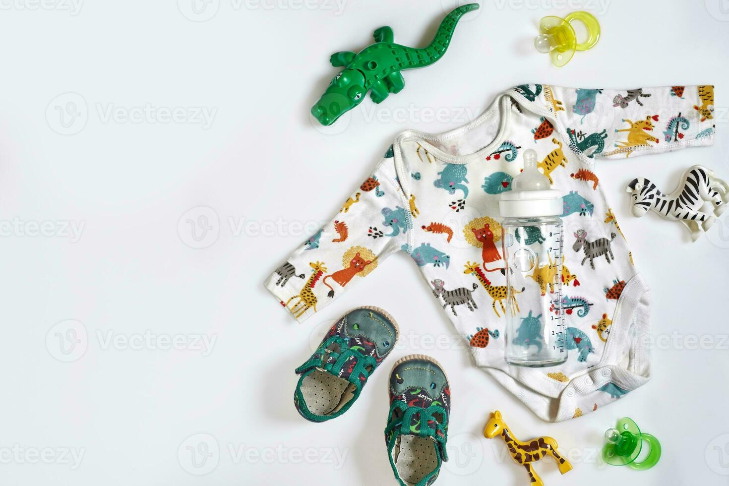 Baby care accessories and clothing on white background, top view photo