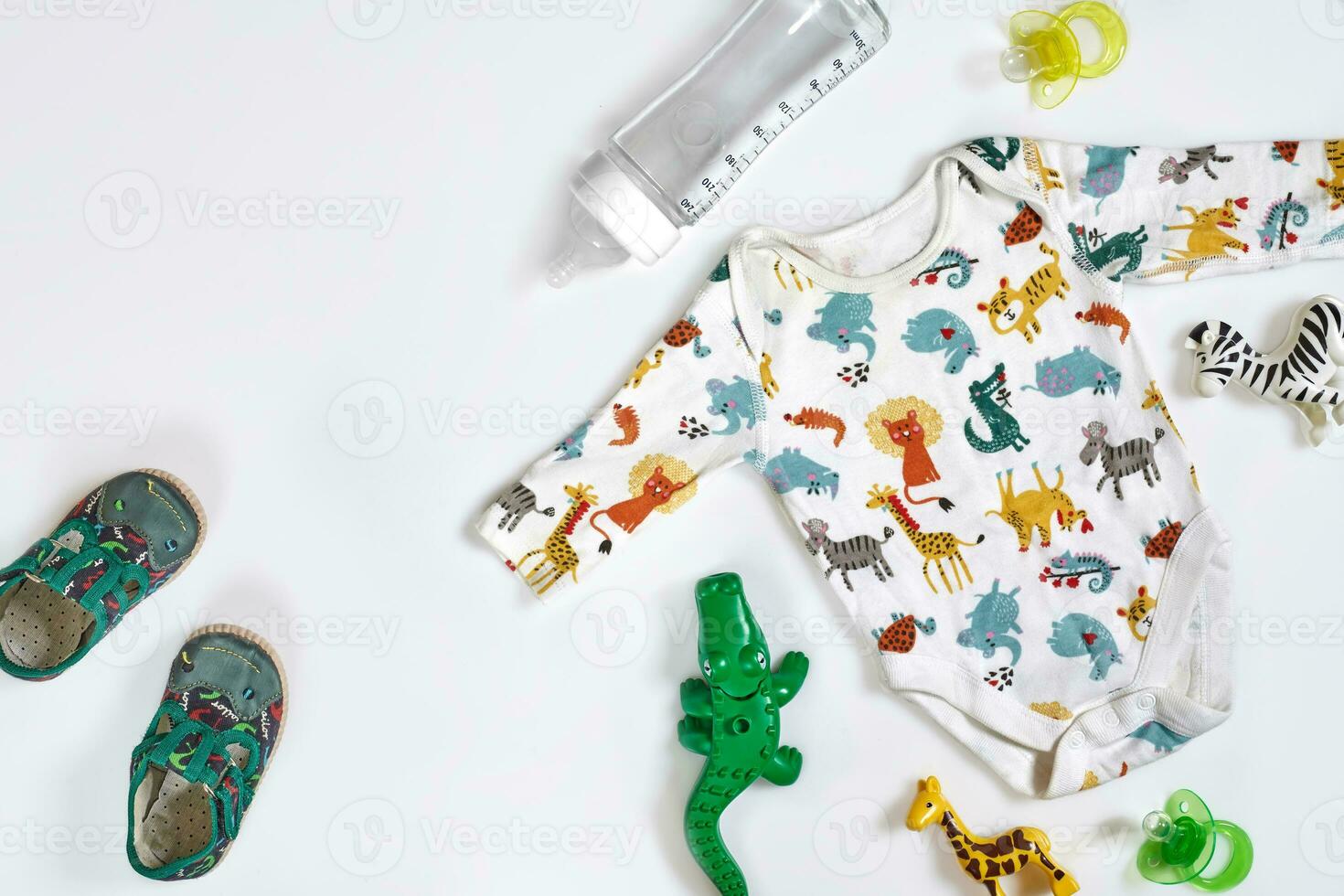 Baby care accessories and clothing on white background, top view photo