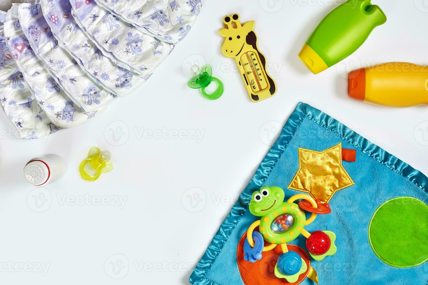 Set of accessories for baby. Pacifier, bottle, diaper, cream on white background. photo